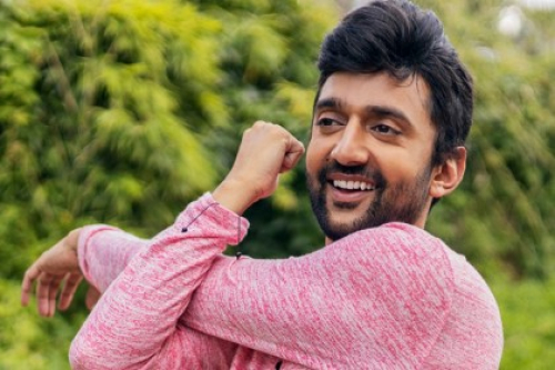 A man stretches his arm across his body ahead of an outdoor yoga session.