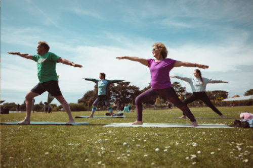 People doing yoga in a park