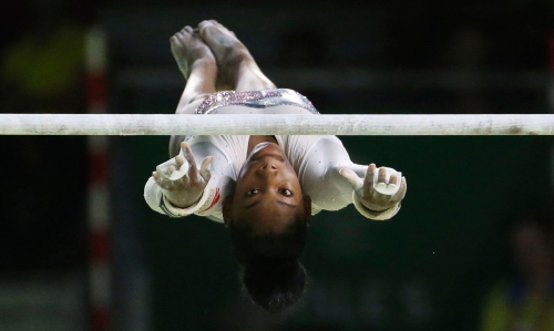 Artistic gymnast Taeja James competes on the asymmetric bars