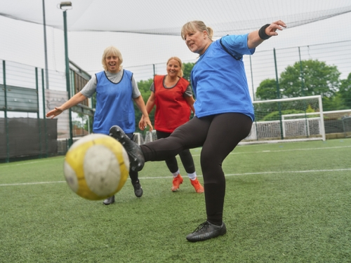 A group of older women play walking football