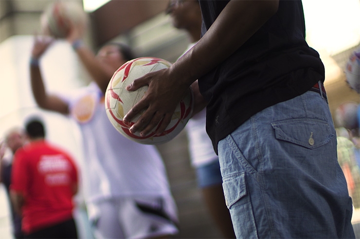A close-up shot of people holding or throwing basketballs