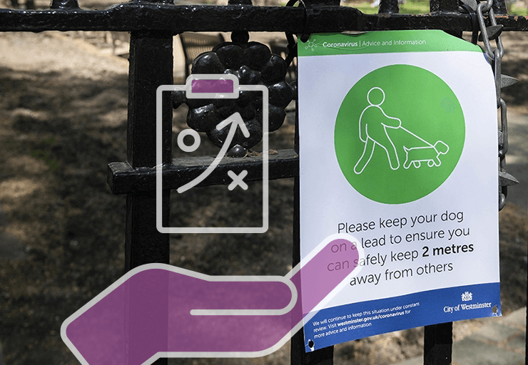 A sign on a gate asking dog walkers to observe social distancing.