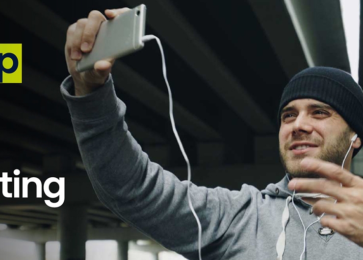 A man records himself on his mobile phone.