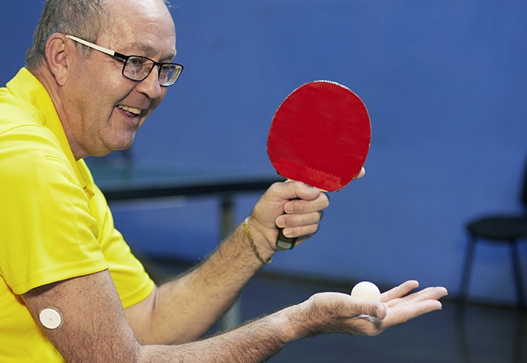 We Are Undefeatable case study Simon, plays table tennis in his wheelchair, with a blood glucose monitor patch on his arm