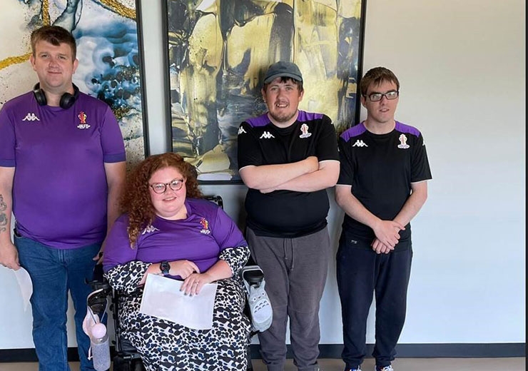 A group of volunteers from the Rugby League World Cup's inclusive volunteer programme pose for a picture