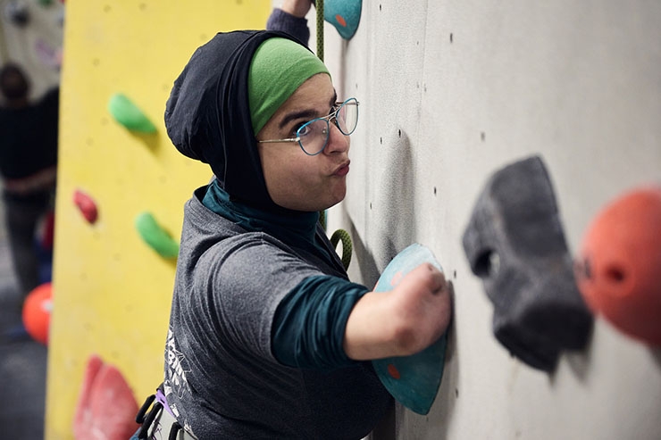 A disabled woman uses a climbing wall