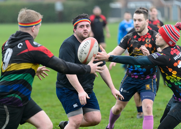 Village Spartans Rugby Club players try to catch the ball during a training session in the park.