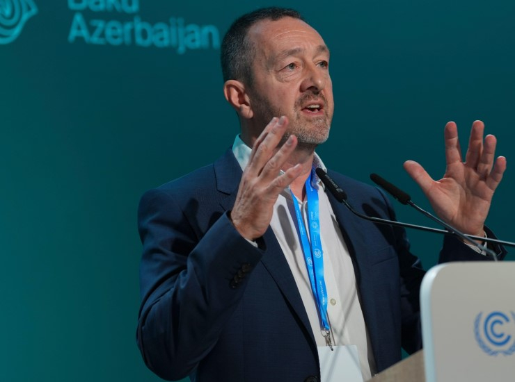 Chris Boardman speaks at a lectern during COP29 in Azerbaijan.