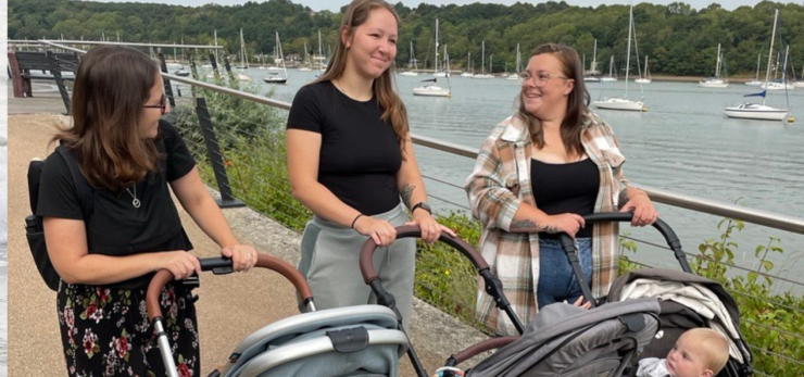 3 mums on a walk pushing their babies in pushchairs 