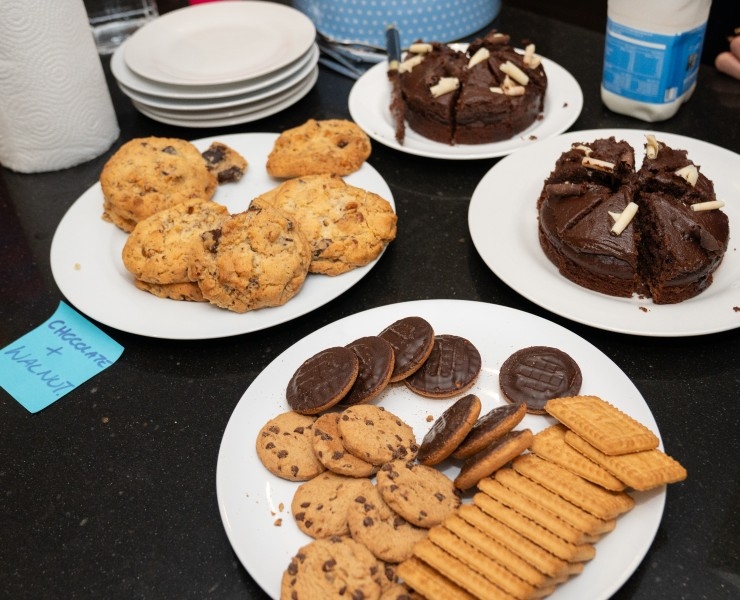 Four plates of cake and biscuits