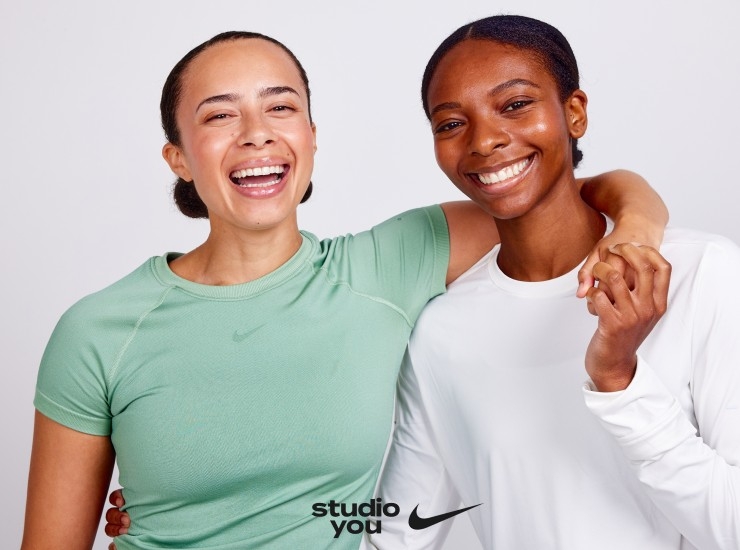 Two Studio You x Nike trainers embrace and smile at the camera during a promotional photoshoot.
